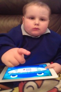Brandon with his very own IPad from Wipe Away Those Tears
